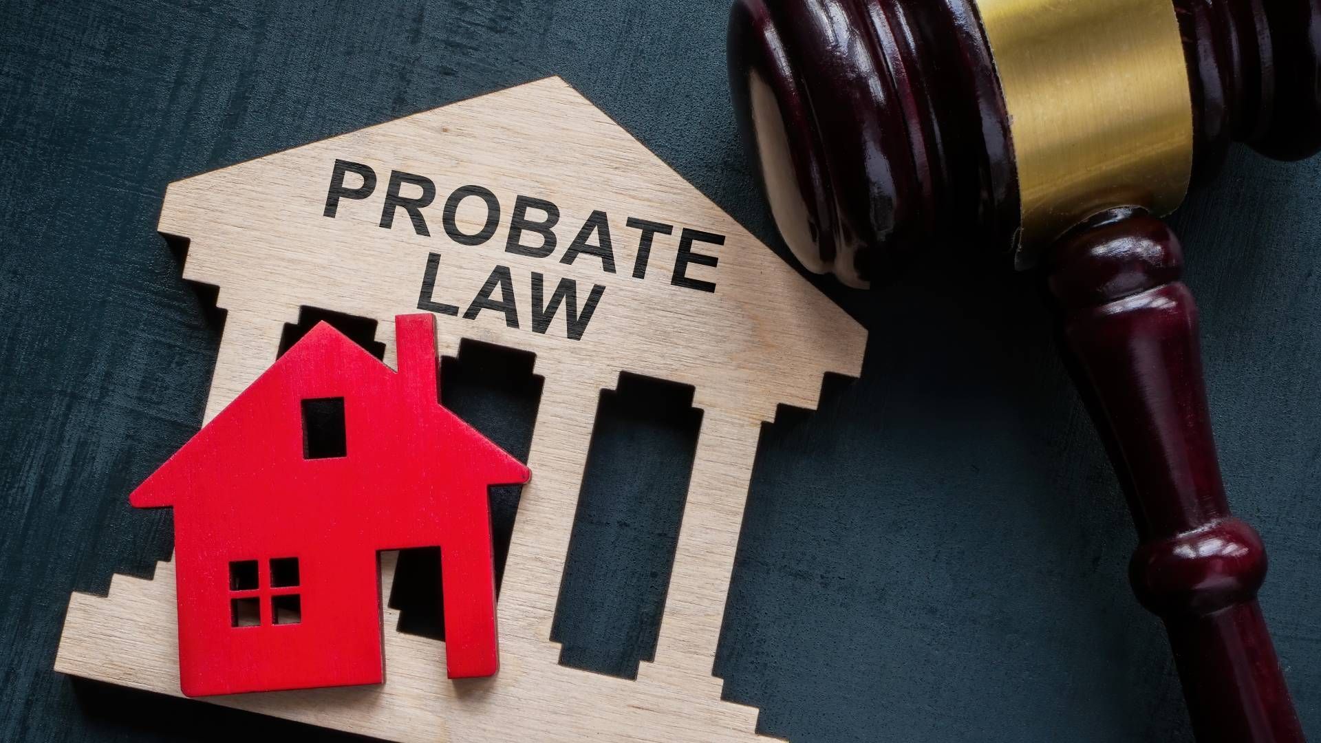 A wooden house with the words `` probate law '' written on it next to a wooden gavel.