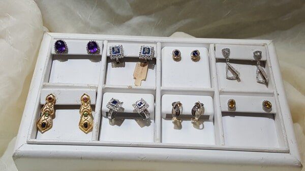 A white box filled with different types of earrings