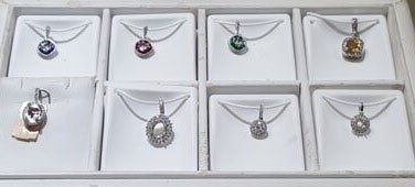 A display case filled with necklaces and pendants