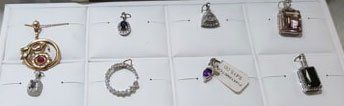 A bunch of pendants are sitting on a table