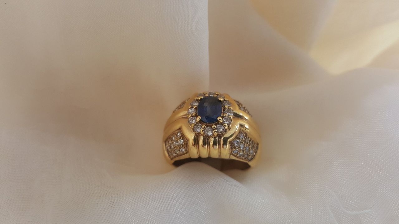A gold ring with a sapphire and diamonds