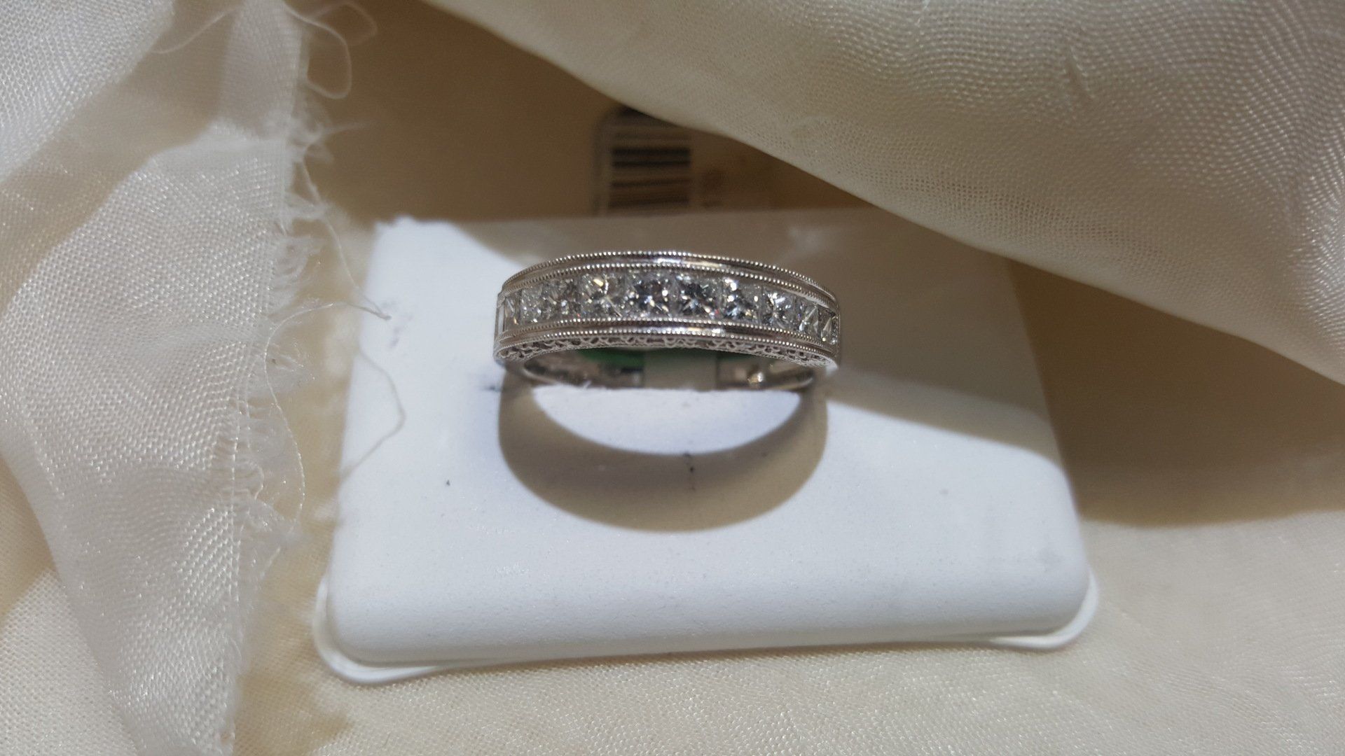 A diamond ring is sitting on top of a white box.