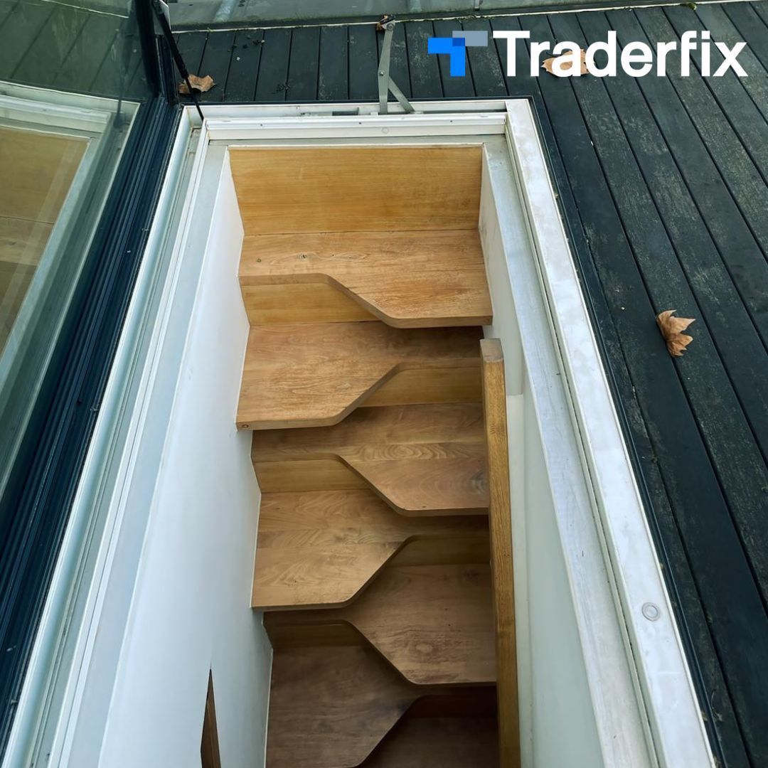 A picture of a wooden staircase with traderfix written on the bottom