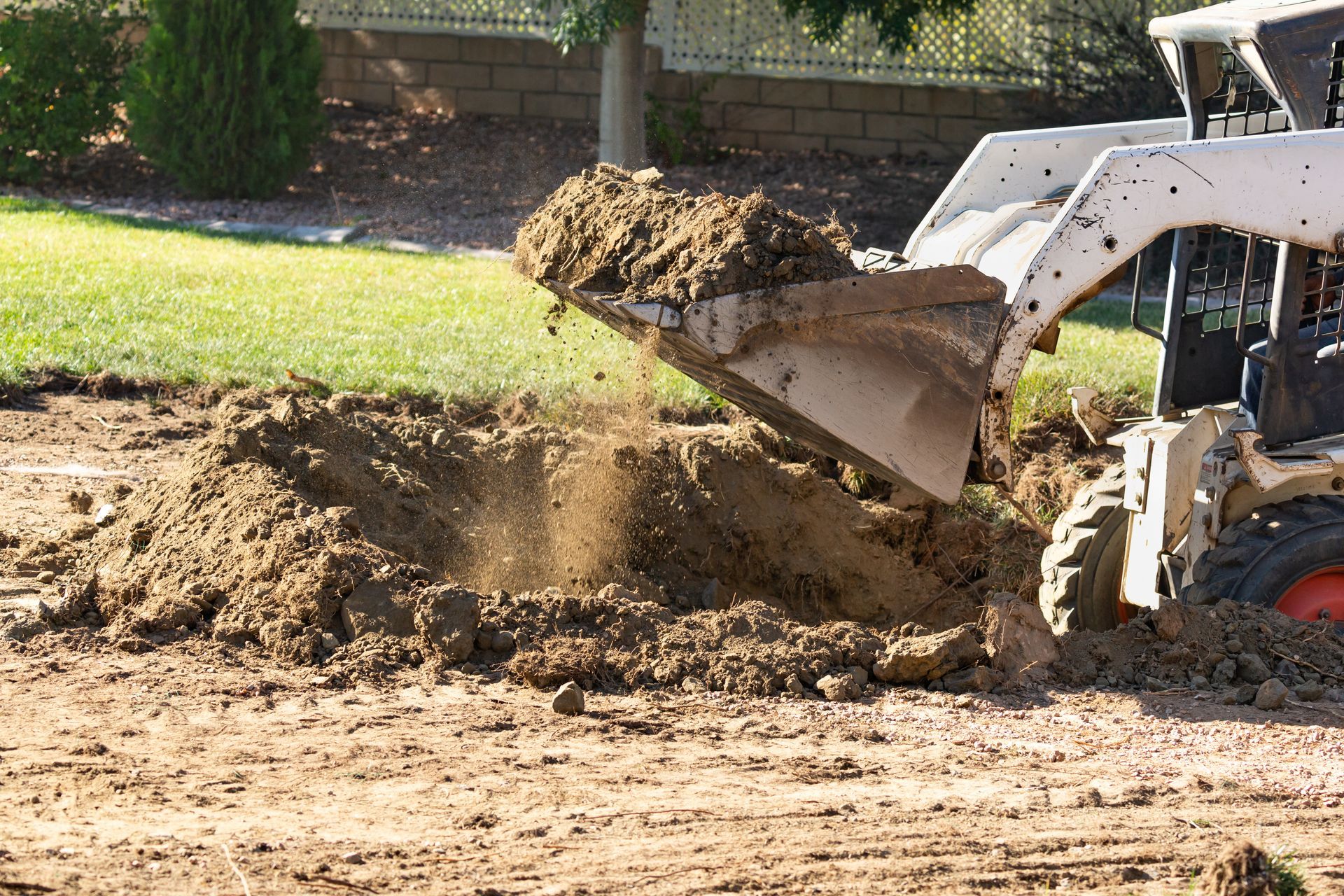 A bulldozer is digging a hole in the ground.