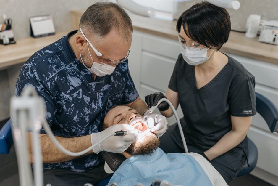 dentists working on a patient's mouth
