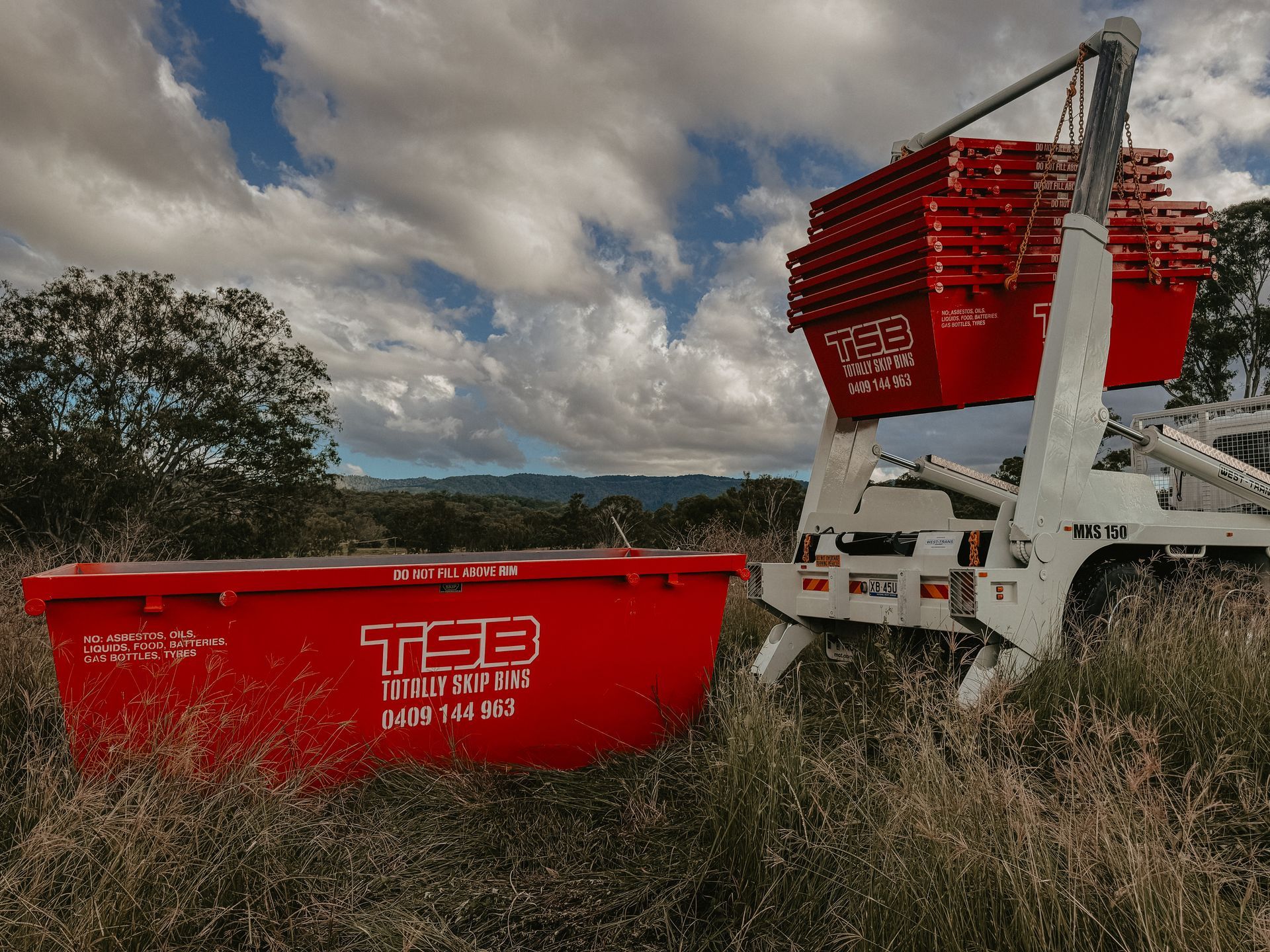 A Dump Truck is Driving Down a Road Next to a Pile of Plastic Bottles — Totally Skip Bins in Palen Creek, QLD