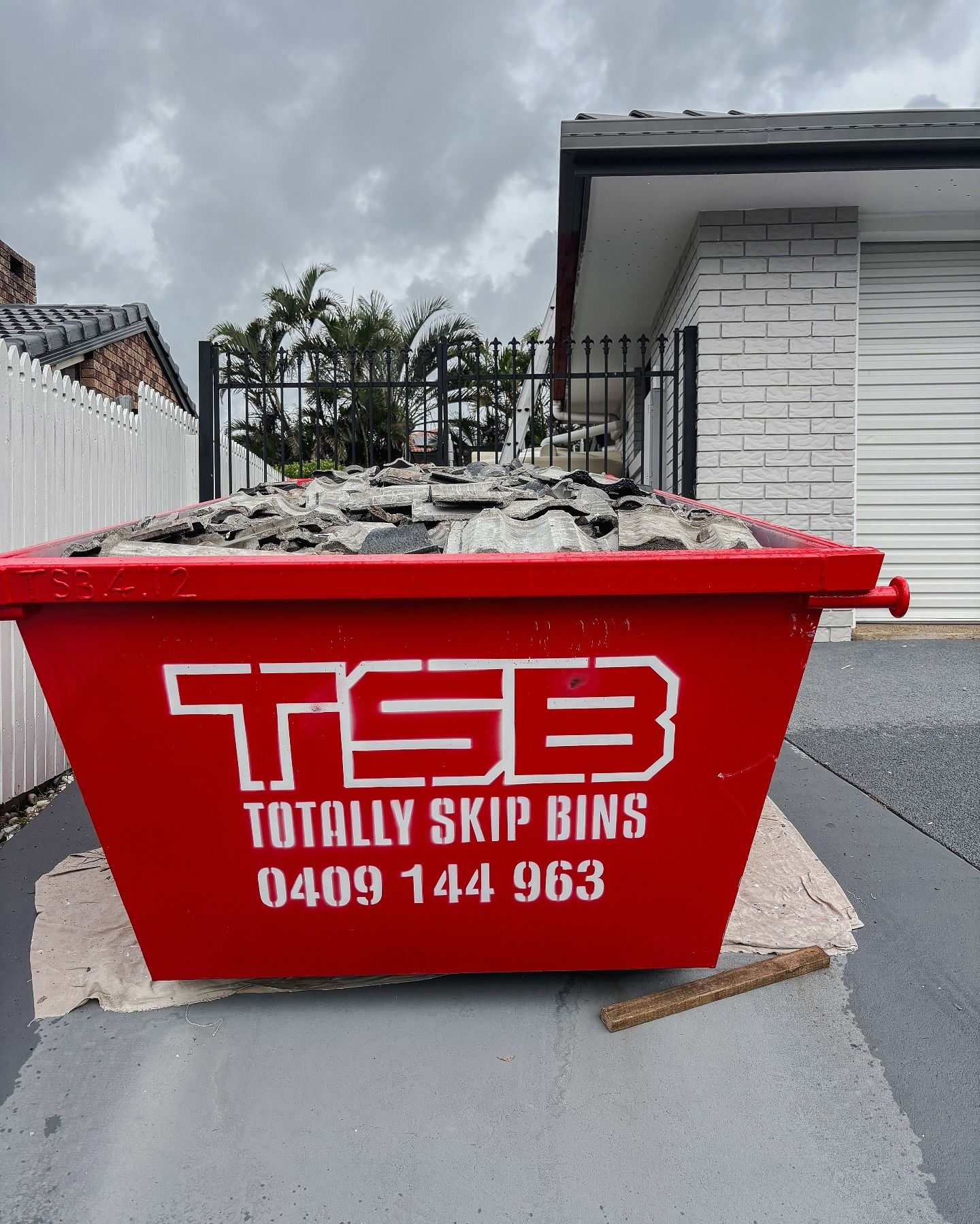 Red Skip Bin Full of Big Rocks
