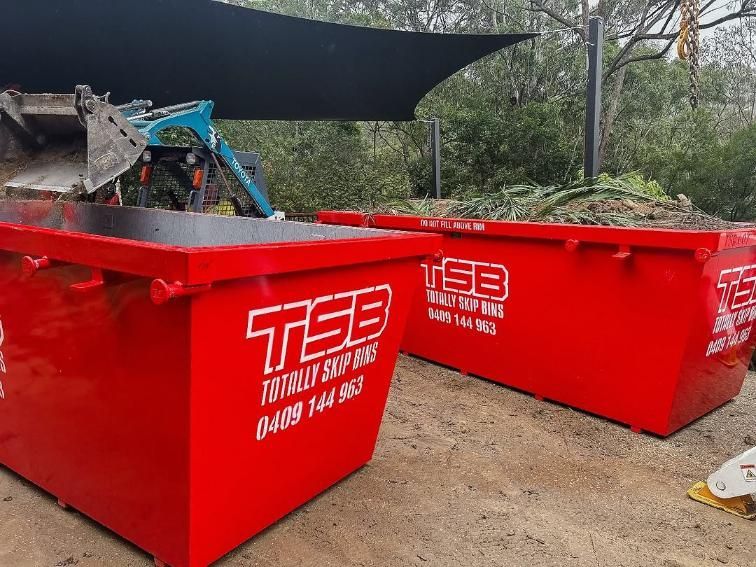 Two Red Dumpsters Are Sitting Next to Each Other on the Ground — Totally Skip Bins in Logan, QLD