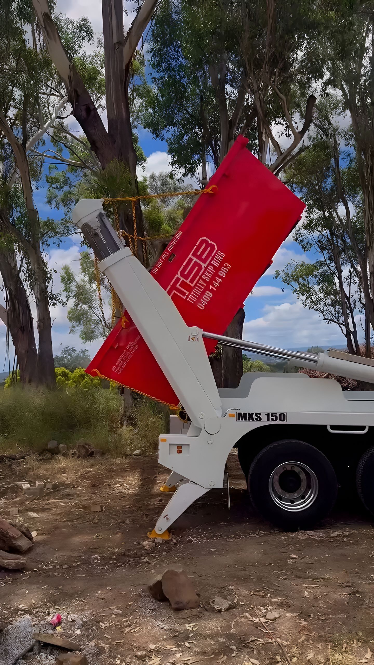 Red Skip is Emptying Trash in a Yard — Totally Skip Bins in Boona, QLD