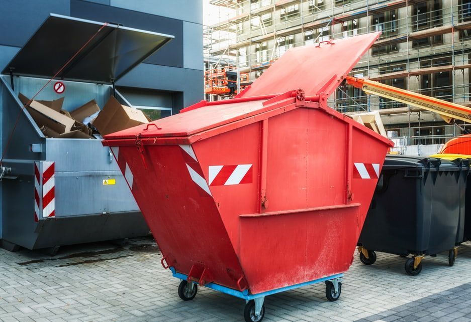 A Red Dumpster With the Lid Open is Parked — Totally Skip Bins in Gleneagle, QLD