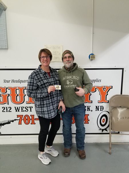 A man and a woman standing in front of a sign that says 212 west