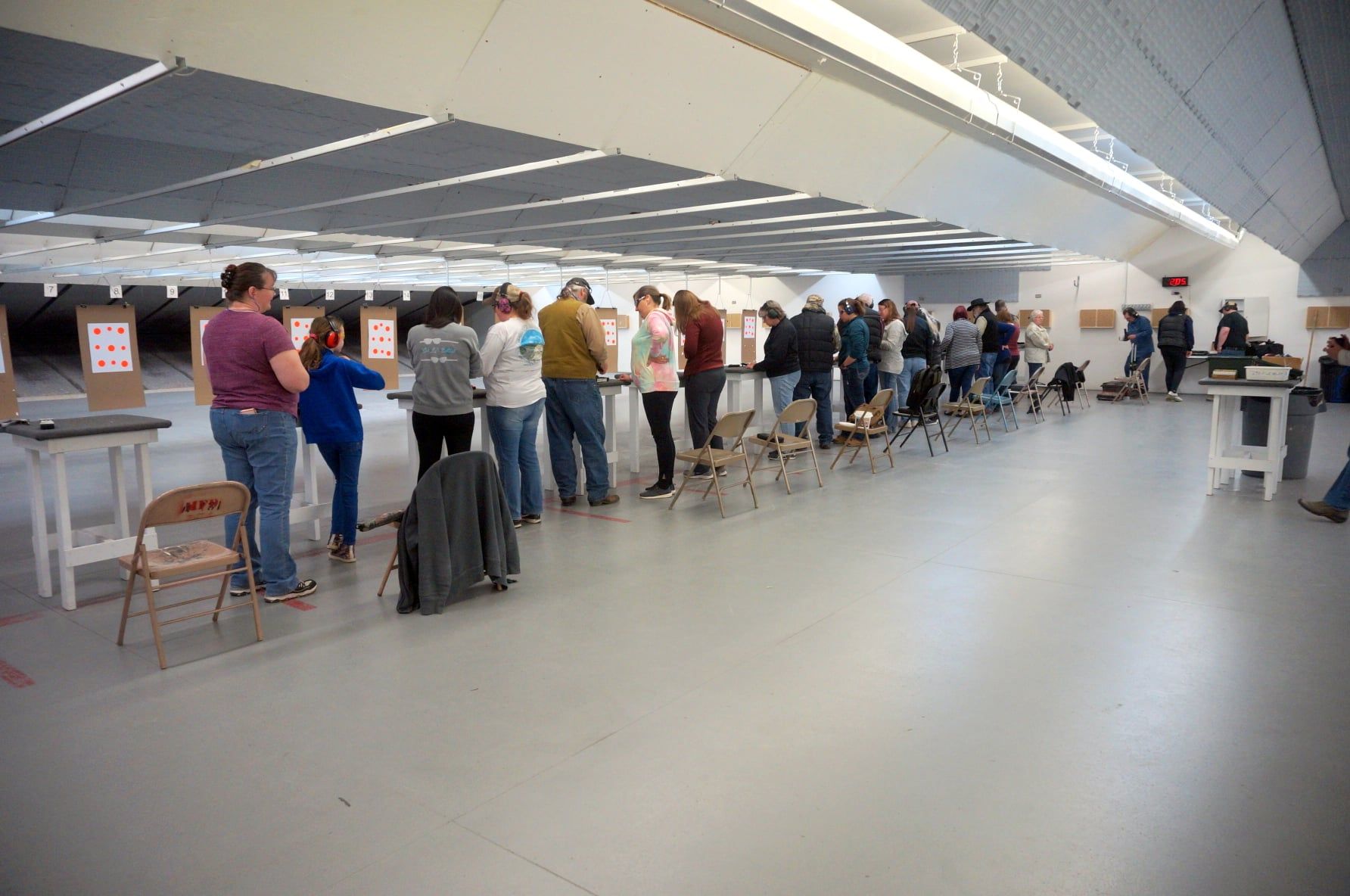 A group of people are standing in a row in a room.