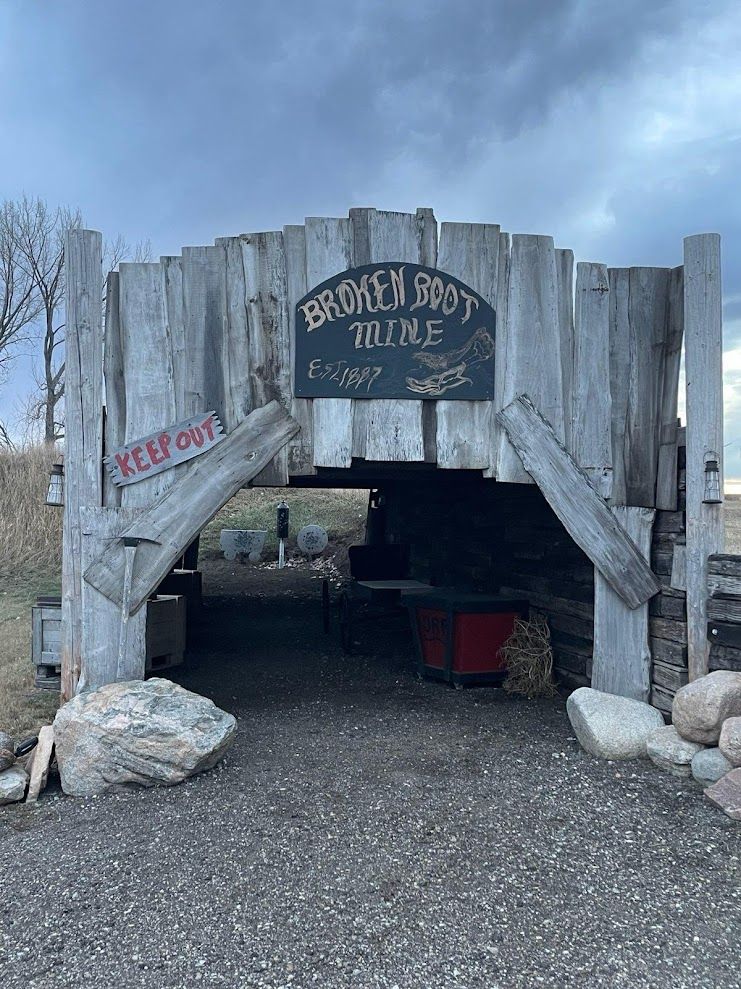 A wooden structure with a sign on it that says `` broken shot wine ''.