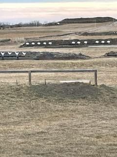 There is a wooden fence in the middle of a field.