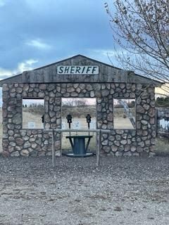 A stone building with a sign that says sheriff on it.