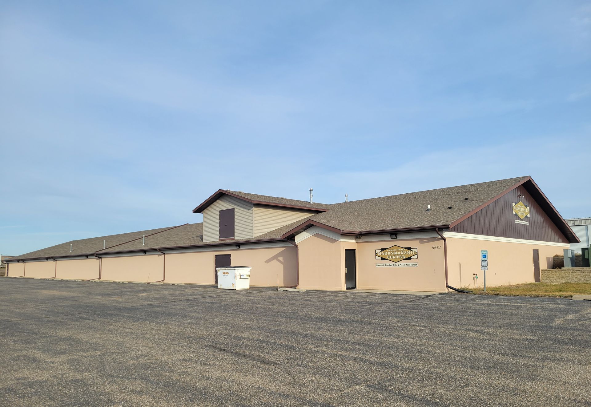 A large building with a lot of windows and a roof