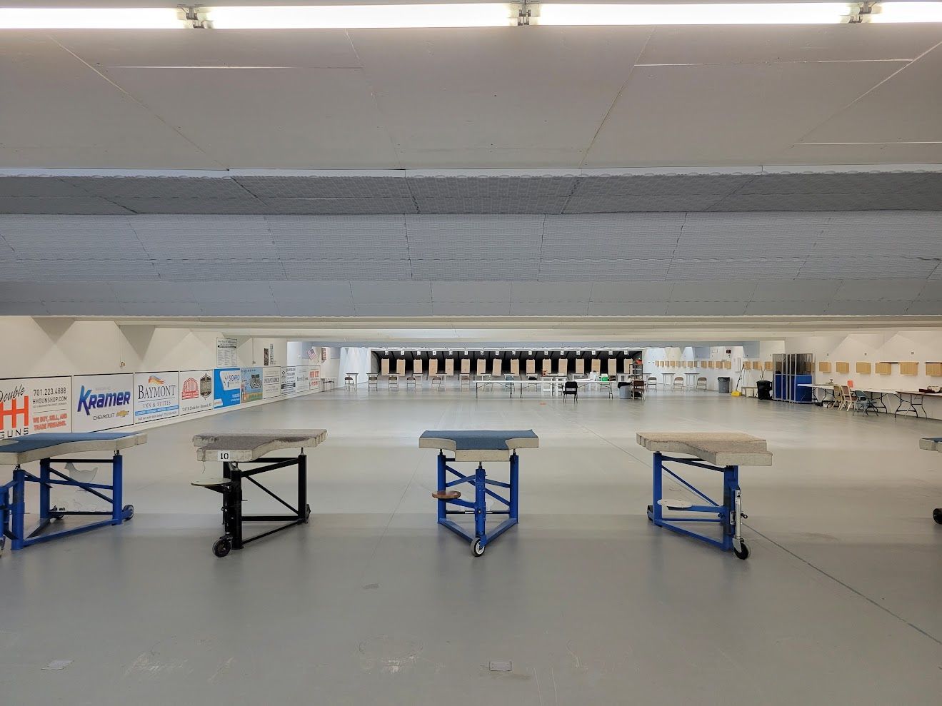 A large empty room with tables and chairs in it.