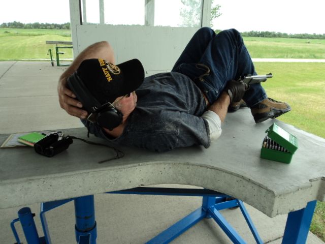 A man wearing a hat that says iowa is laying on a table