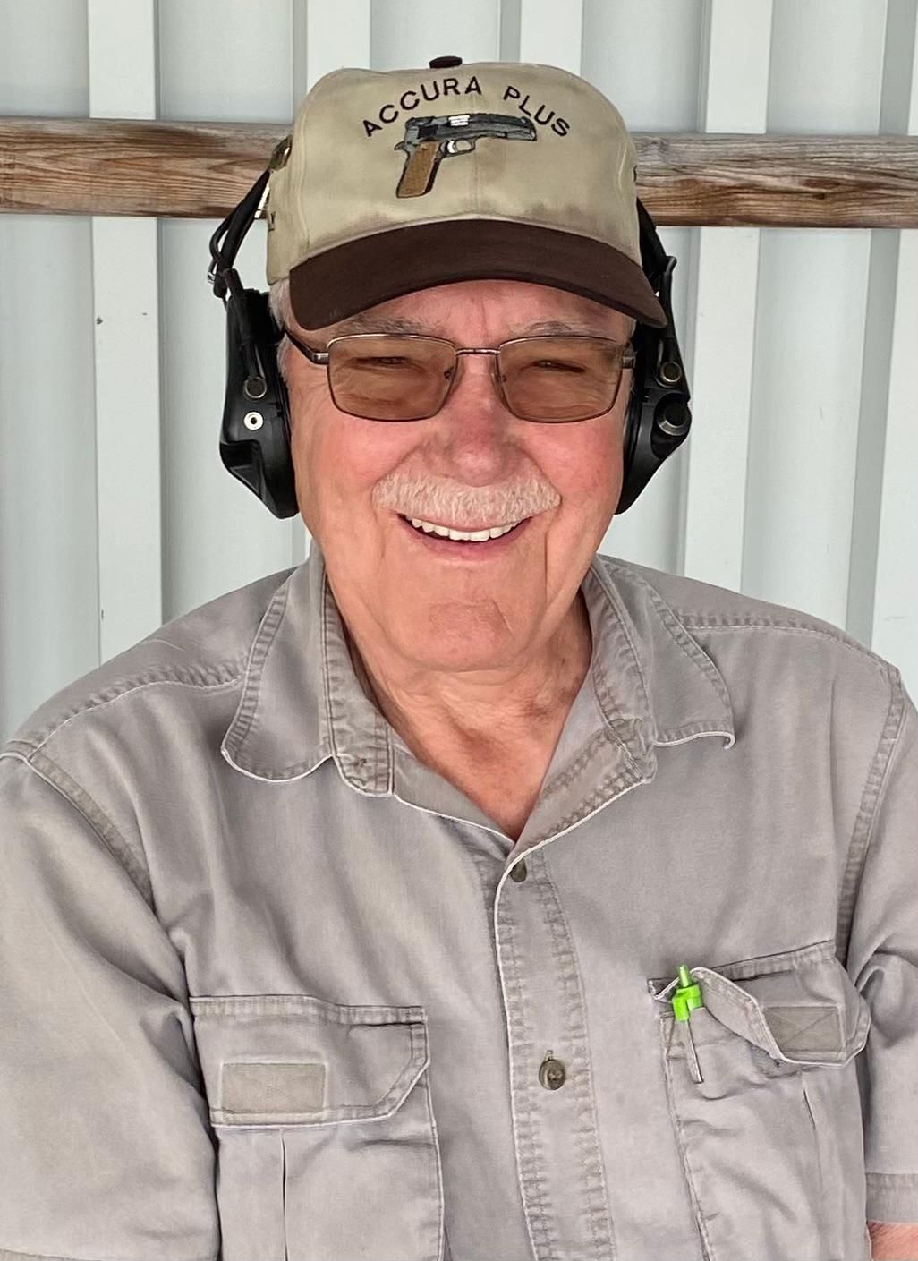 A man wearing a hat that says accura plus on it