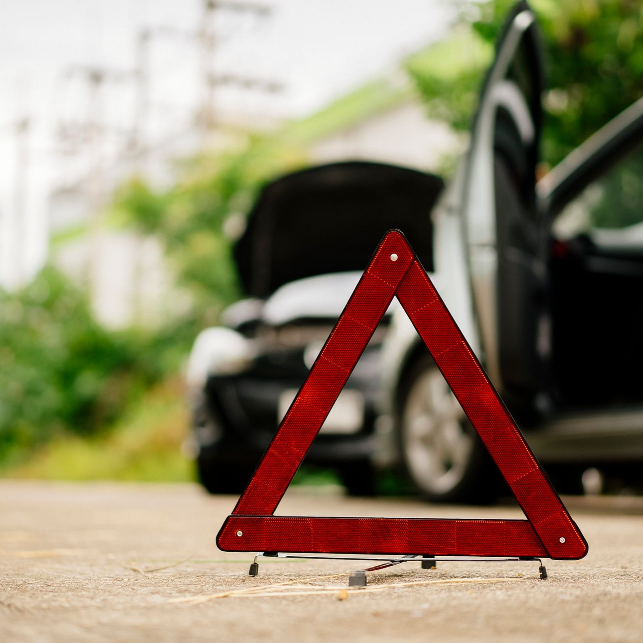 Car flipped over, smoke rising, in a gold circle.