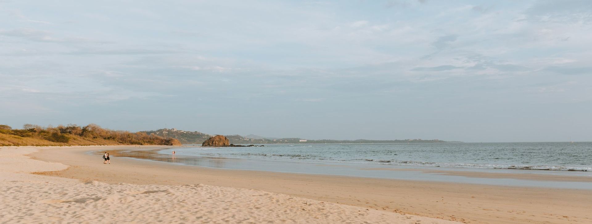 A blurry picture of a beach with a person walking on it.