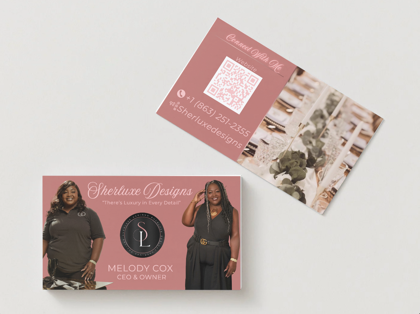 Two women are standing next to each other in front of a logo for sherluxe designs