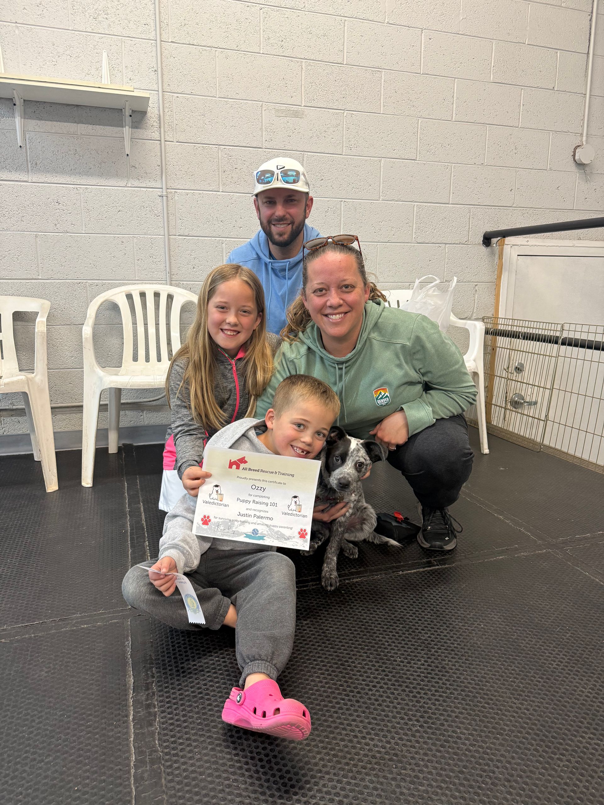 A family poses with their dog for graduation.