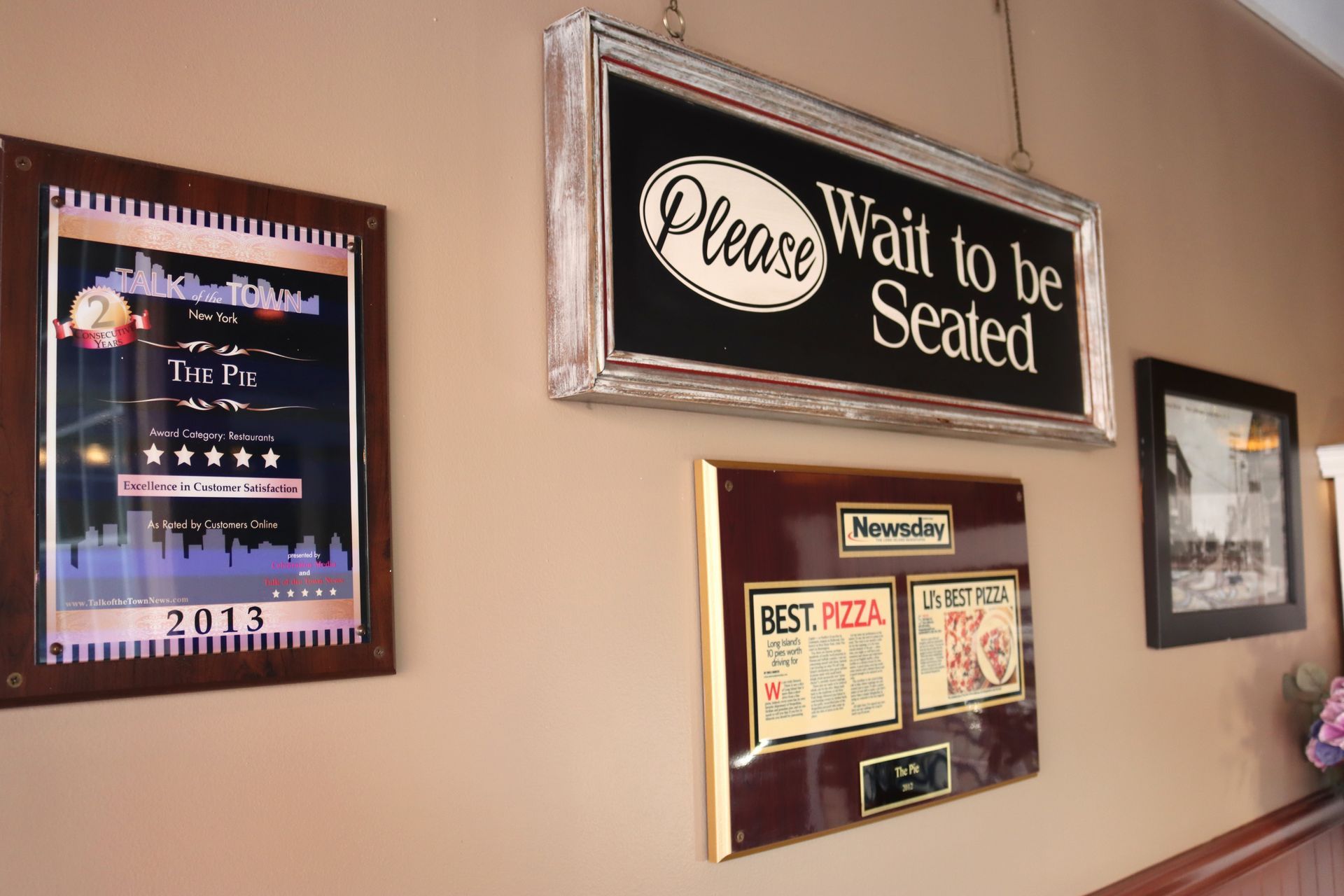 A sign on a wall that says please wait to be sealed