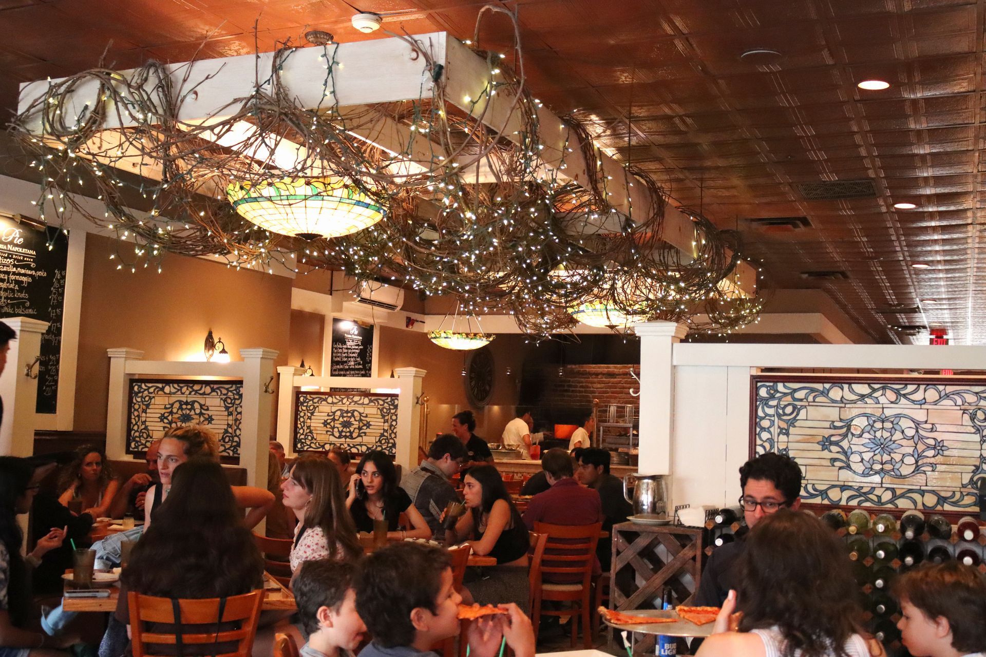 A group of people are sitting at tables in a restaurant