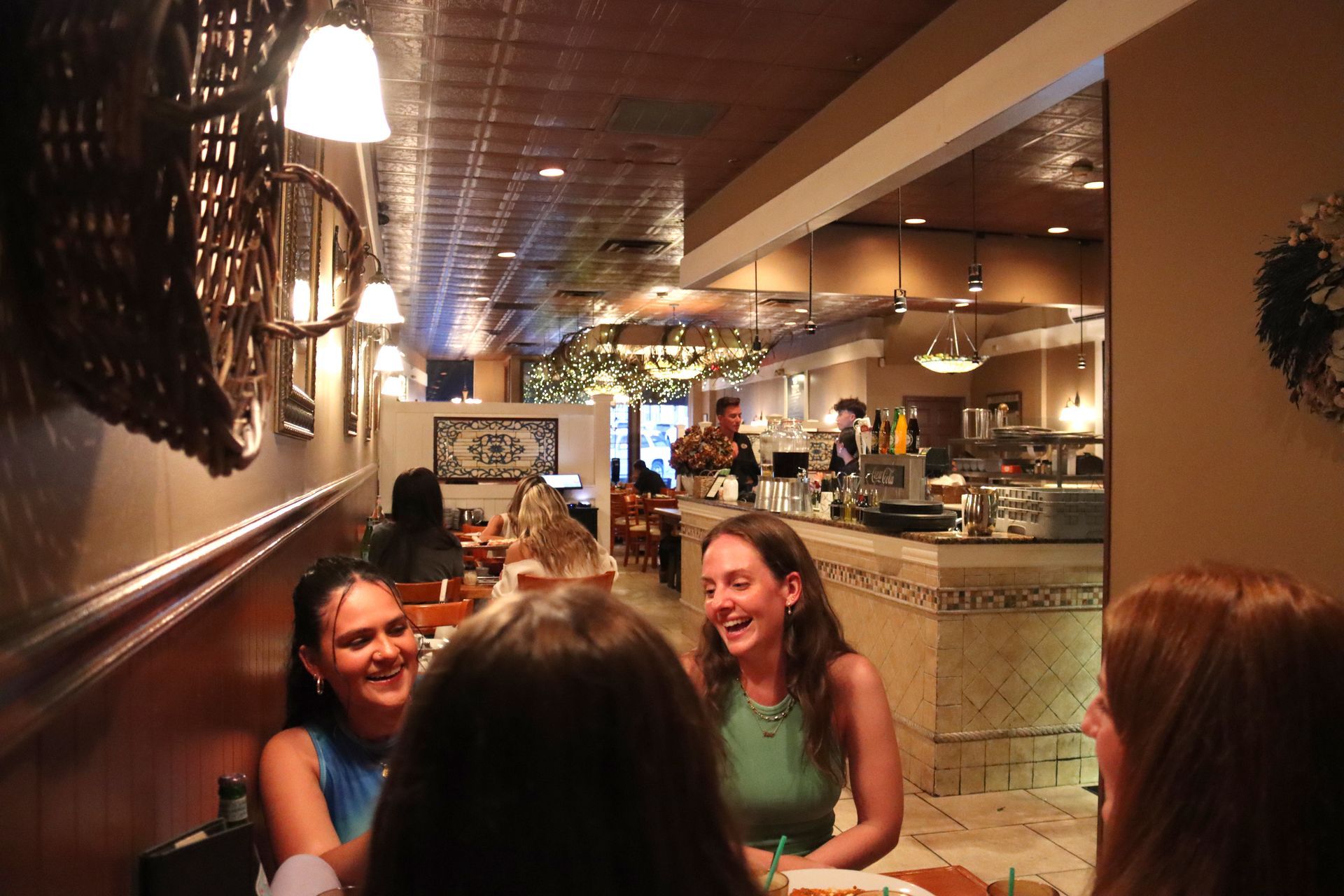 A group of women are sitting at a table in a restaurant