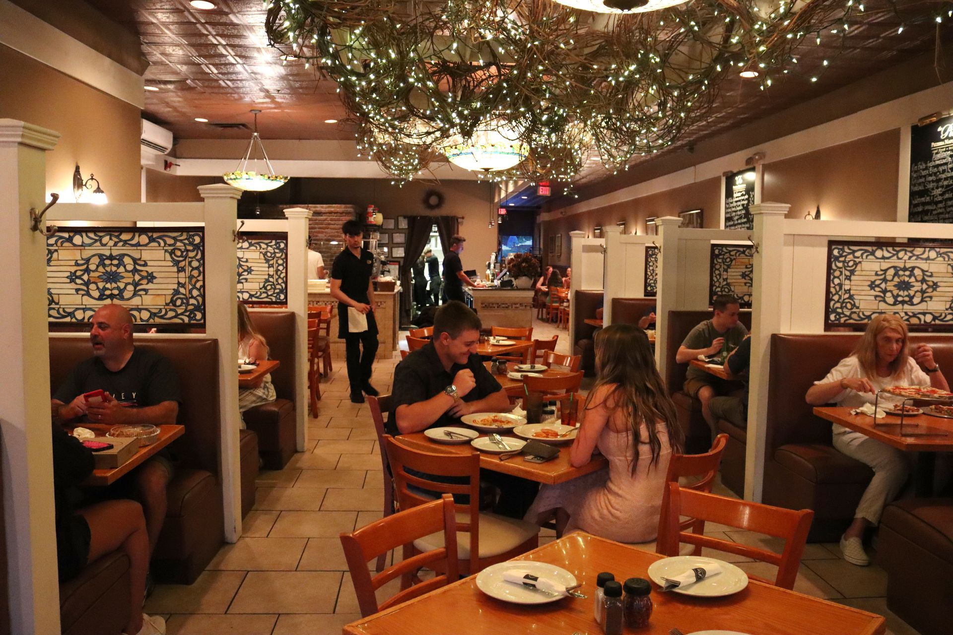 A group of people are sitting at tables in a restaurant.