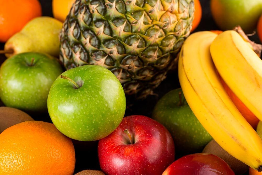 There are many different types of fruits on the table.