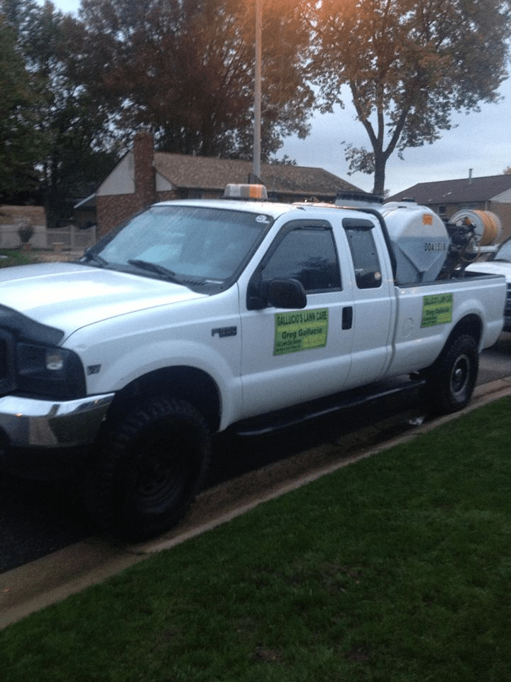 A white truck is parked on the side of the road