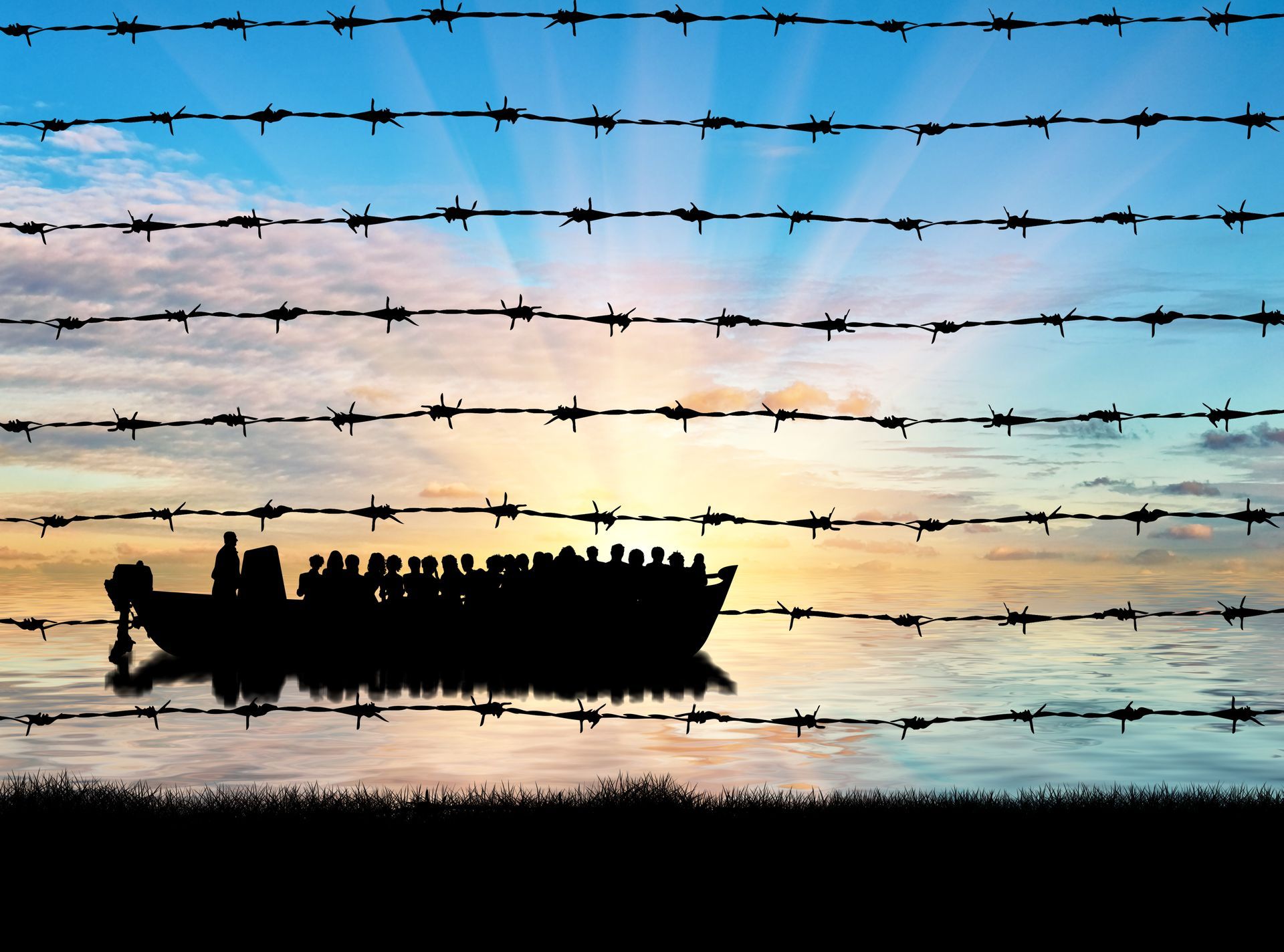 A silhouette of a boat with a barbed wire fence in the background