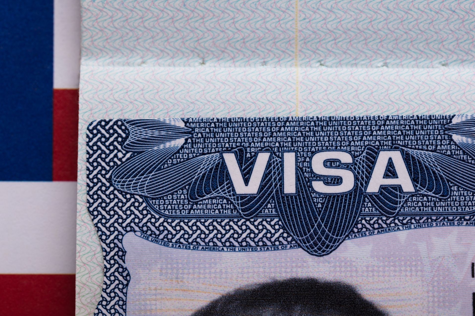 A close up of a visa with an american flag in the background