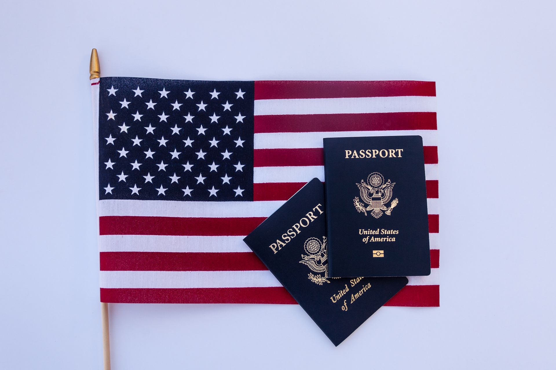 Two passports are sitting on top of an american flag