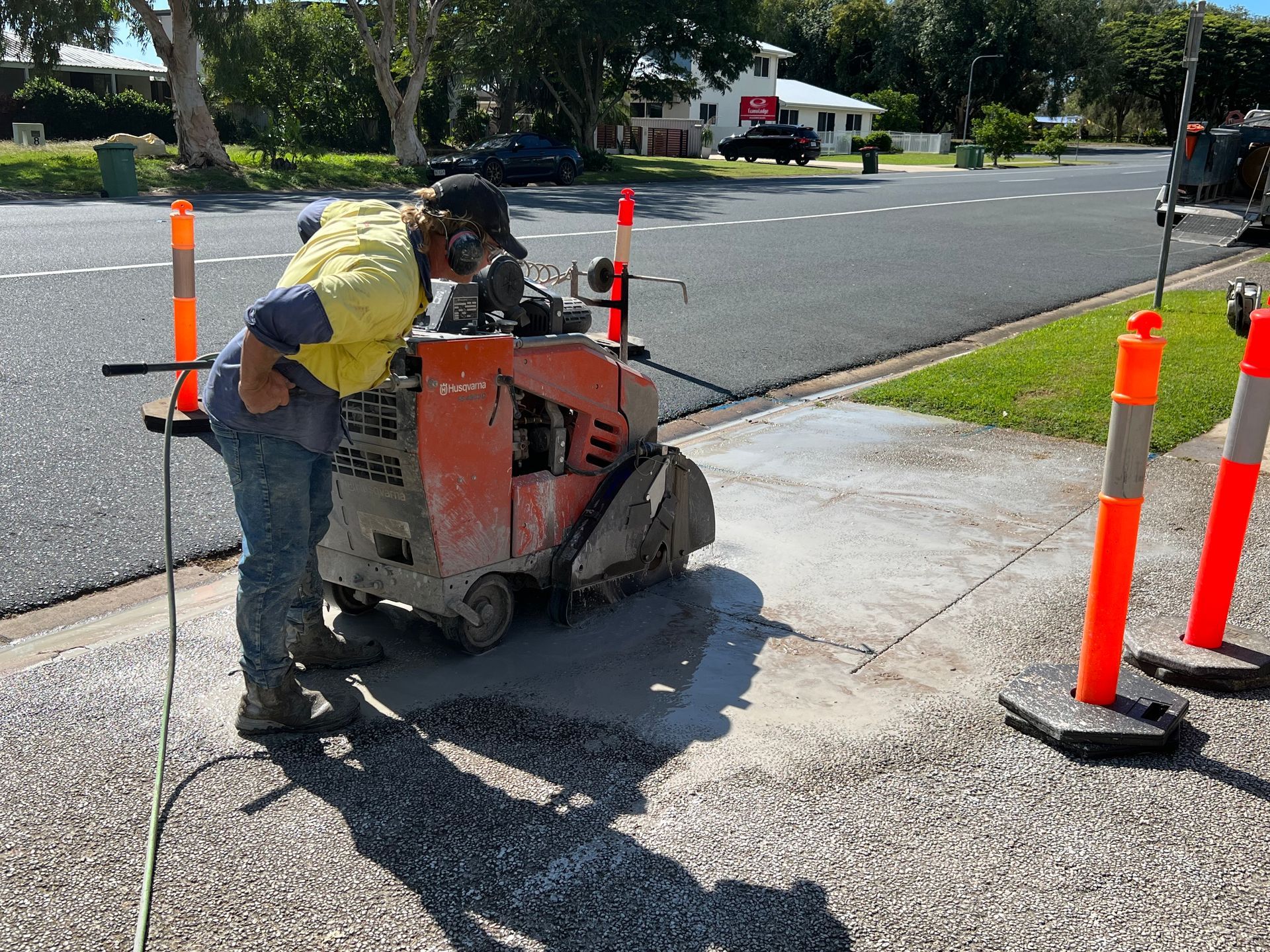 Worker Using a Concrete Saw on a Sidewalk — Ablecut Concrete Cutting & Coring In East Mackay, QLD