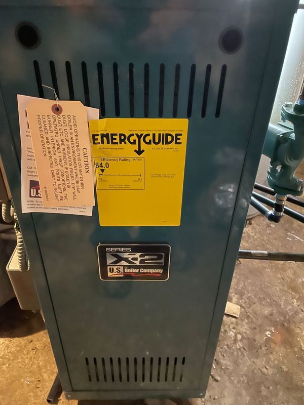 Blue boiler with yellow energy guide label and attached tags.