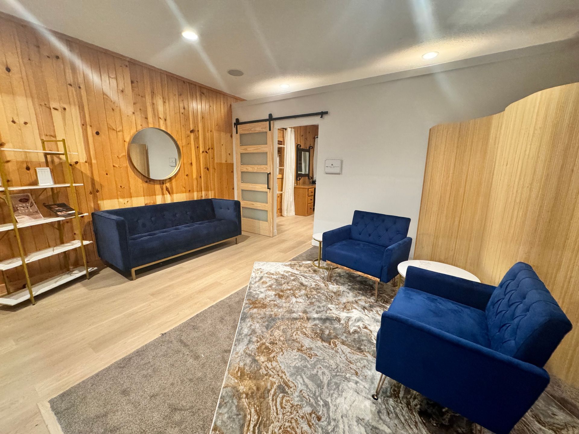 There is a couch and two chairs in the living room.