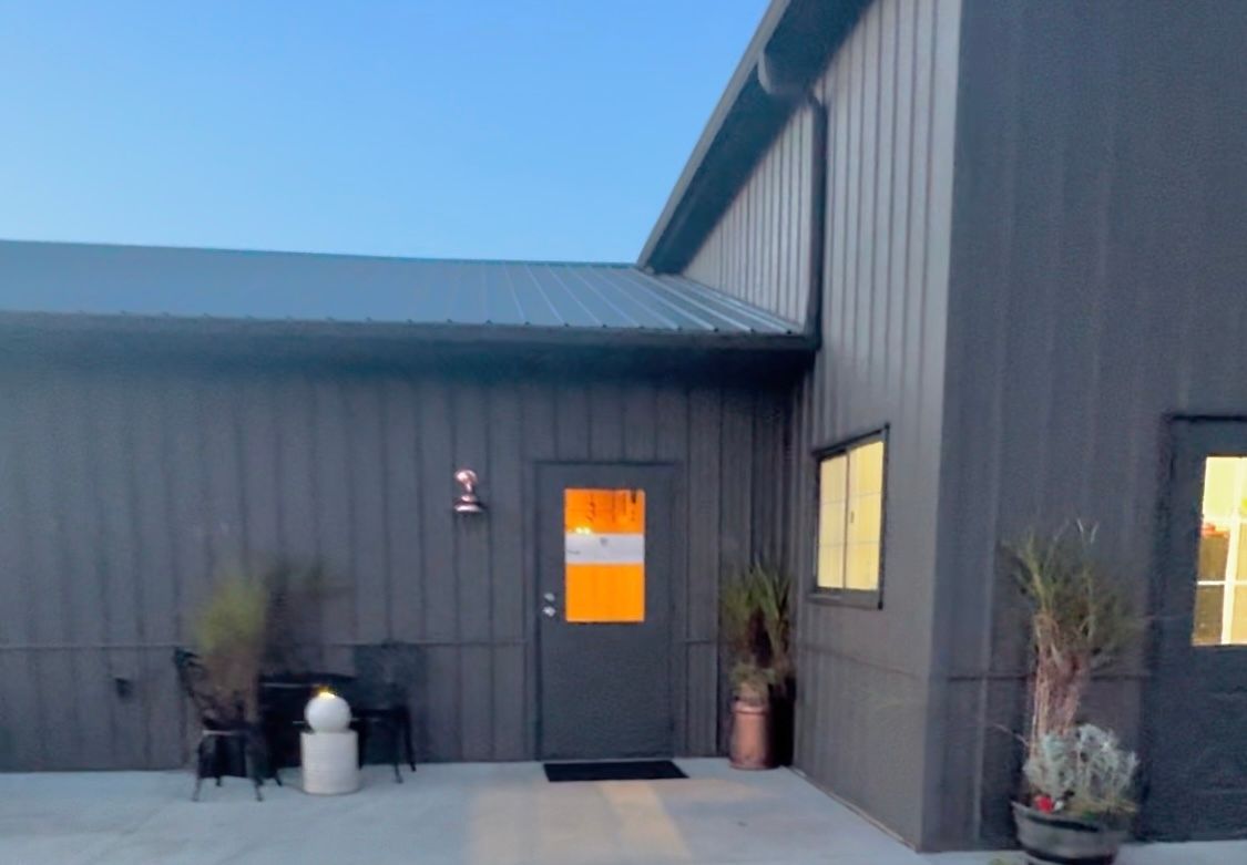 The front of a building with a door and a window.
