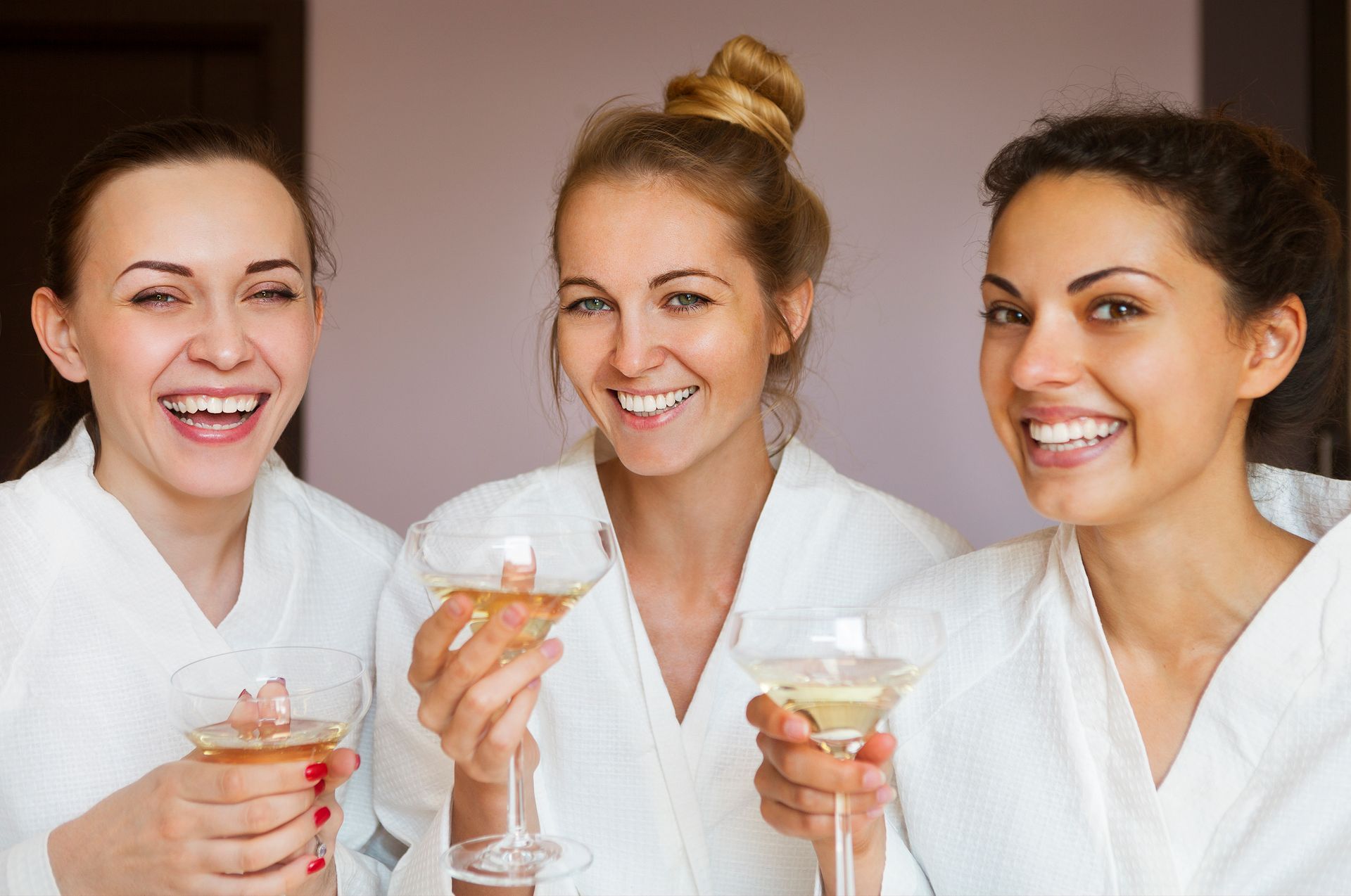 A group of women are posing for a picture together and smiling.