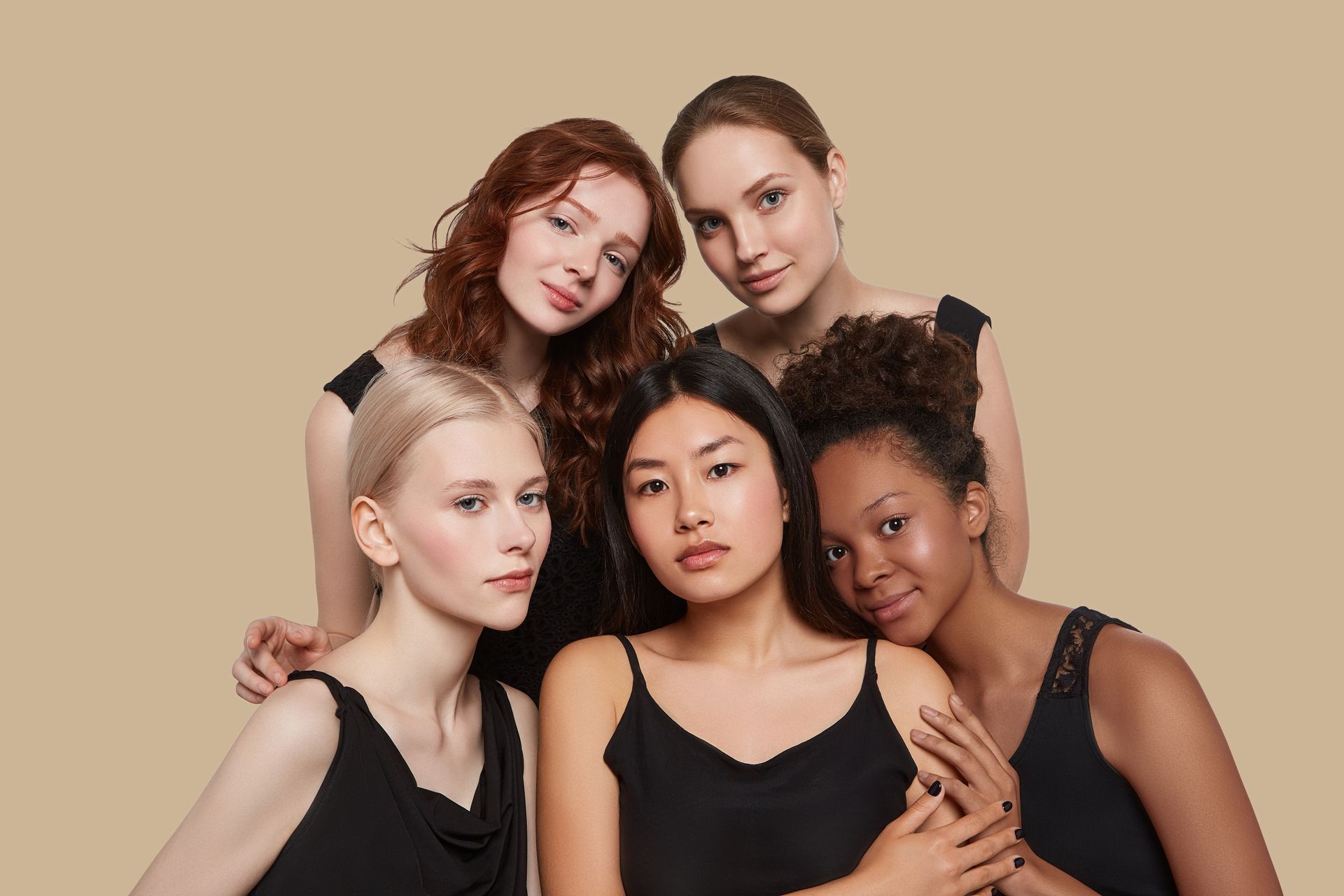 A group of women of different races are posing for a picture together.