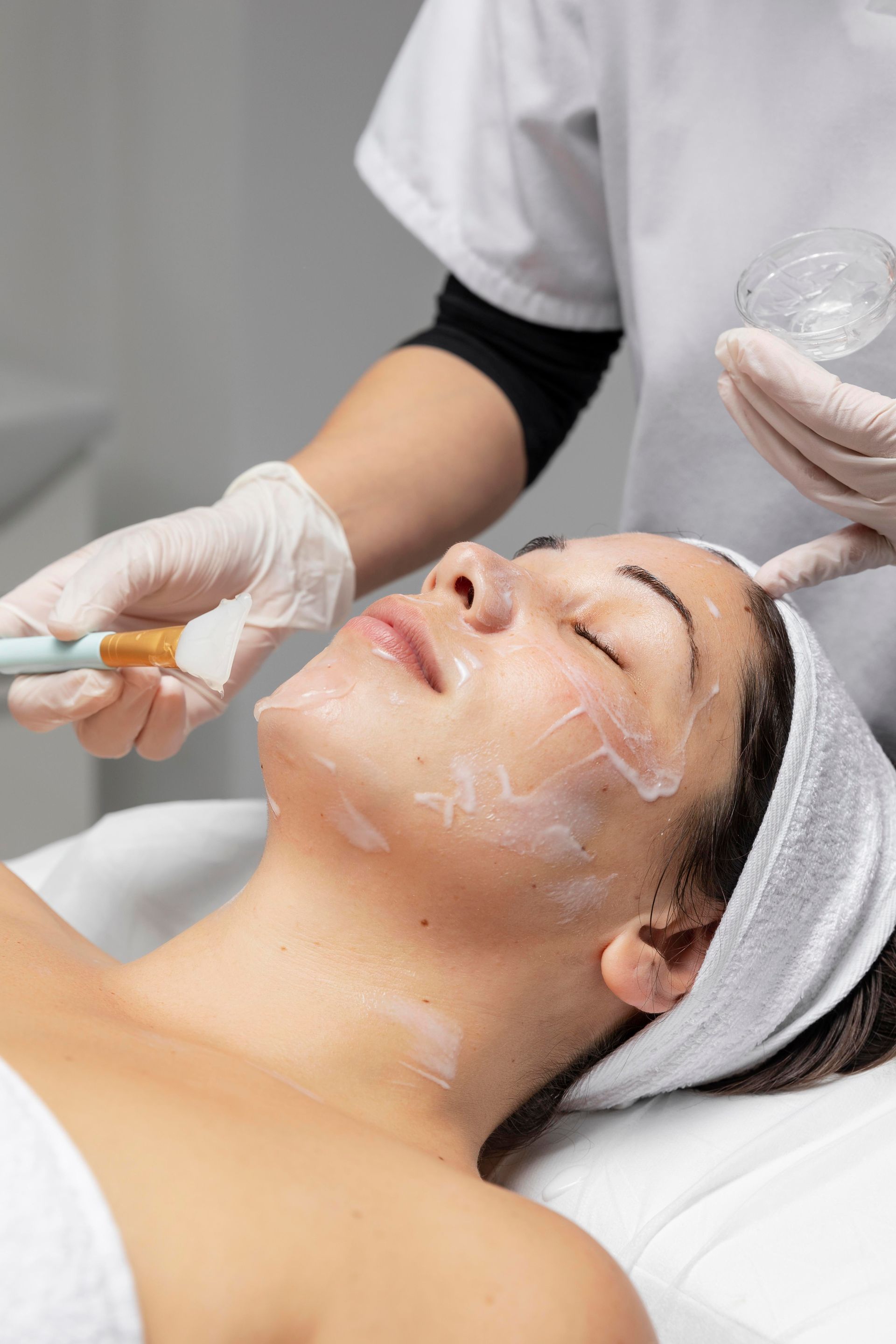 A woman is getting a facial treatment at a spa.