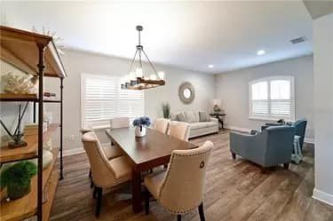 Dining room with a table and chairs, a couch, and a bookshelf.