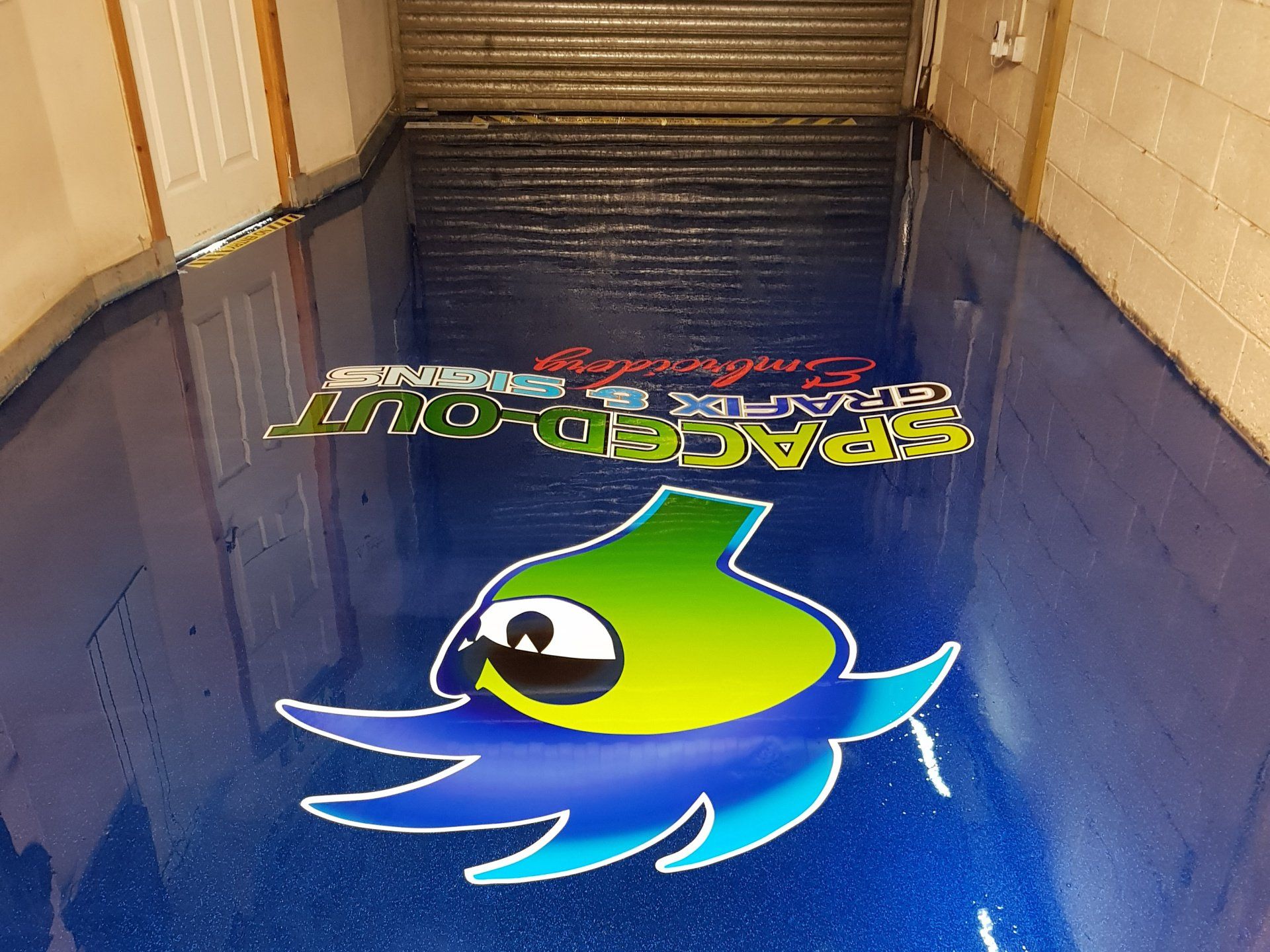 Corporate sign embedded in metallic resin floor