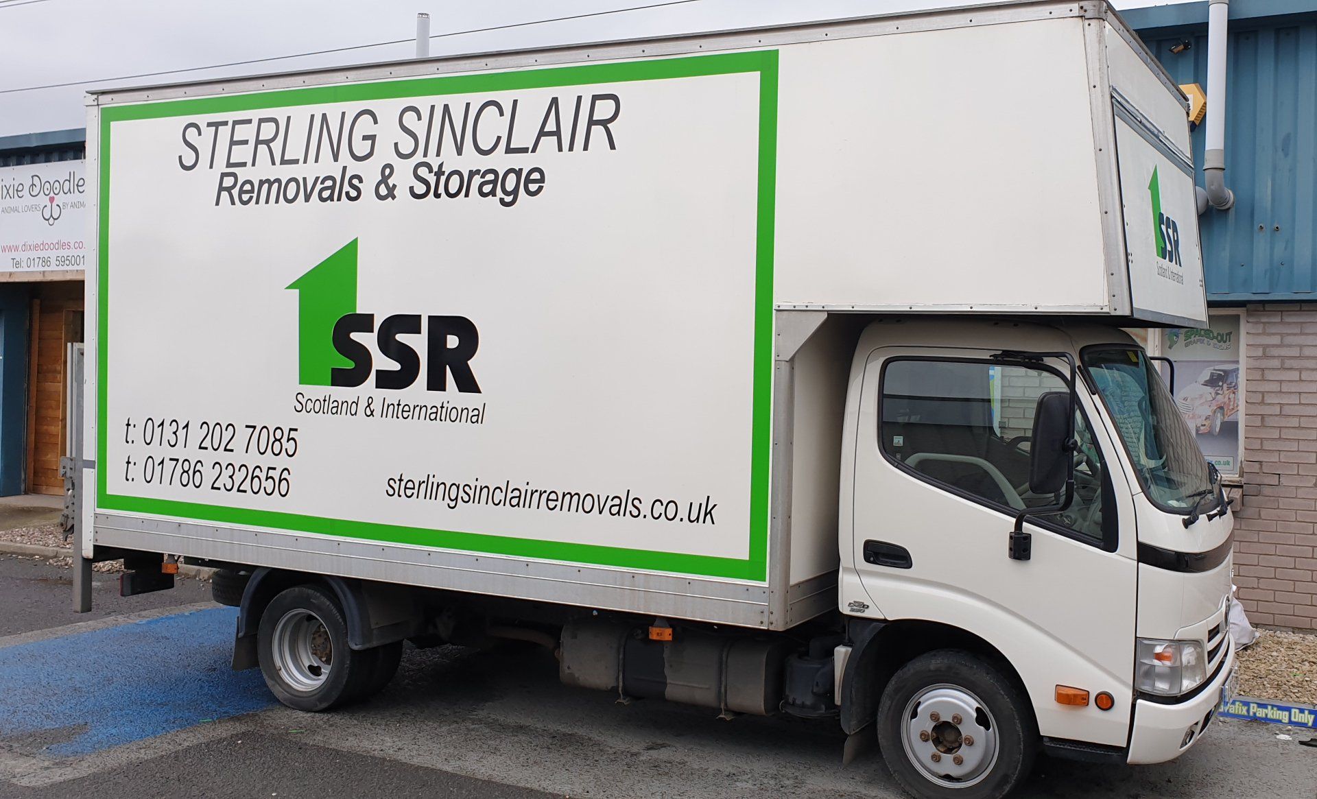 Car signs on a removal truck, side view