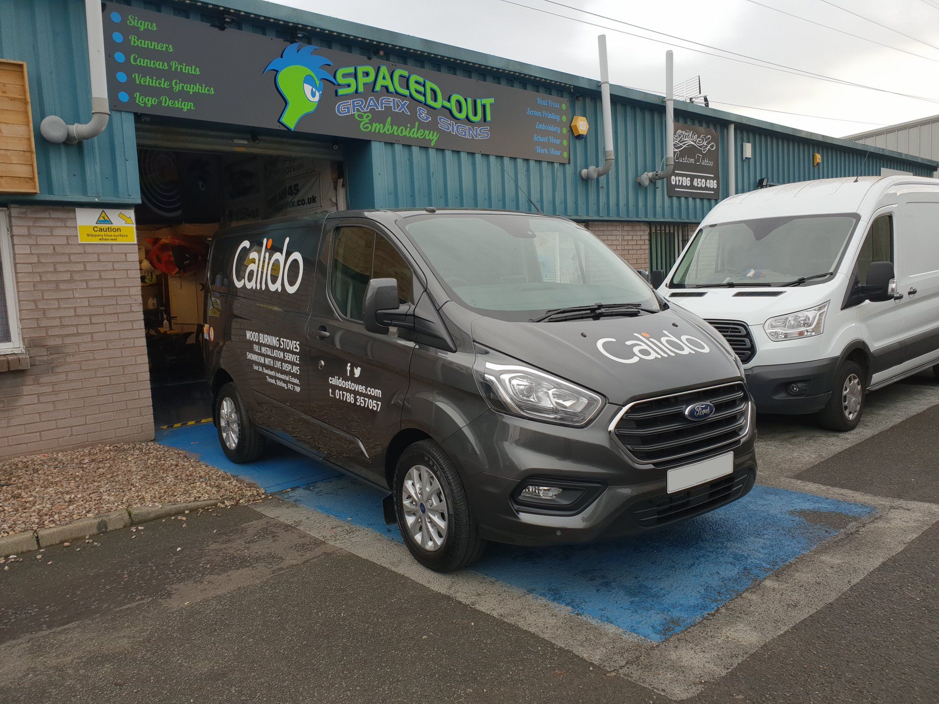 Car signs on a Ford Transit van in grey, front view