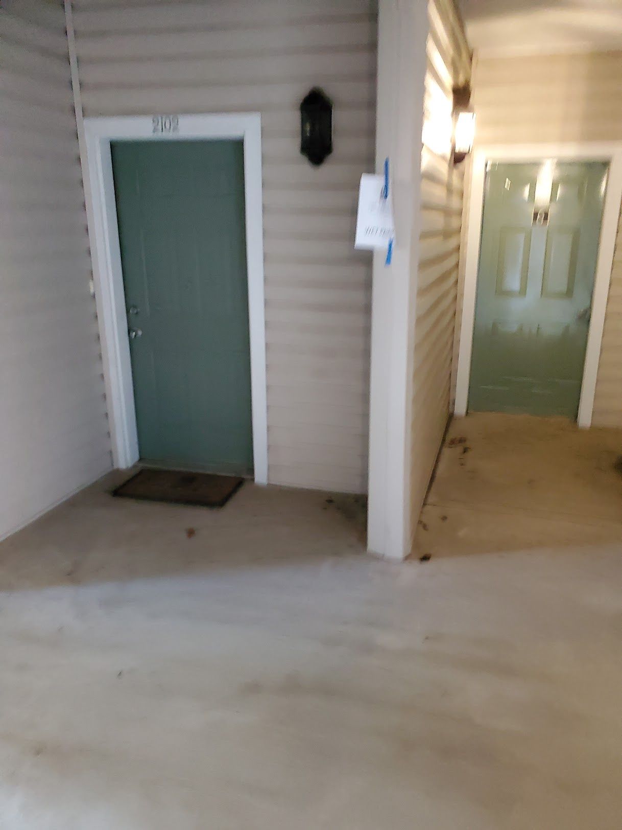 There are two doors in the hallway of a building.