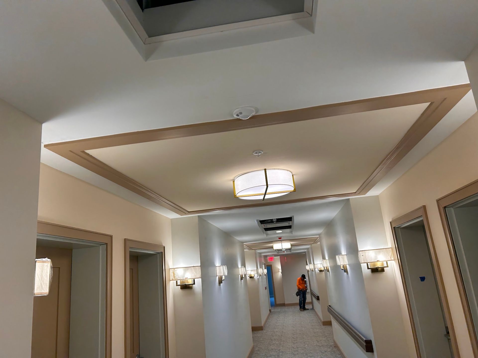A long hallway with a light on the ceiling