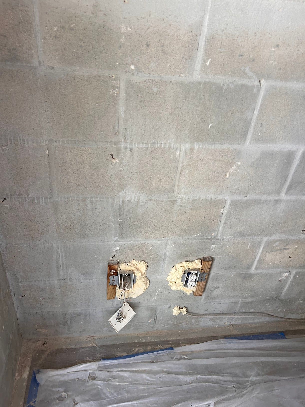 There are two holes in the ceiling of a brick wall.